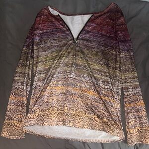 Long sleeve colorful half zip T-shirt with a floral pattern.